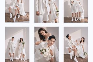 Cặp đôi trẻ trung tạo dáng tự nhiên trong studio với trang phục váy cưới trắng và vest trắng quần short, mang phong cách hiện đại, năng động với tông màu trắng sáng.